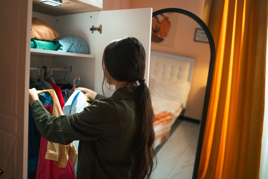 Woman organizing clothes in her new custom closet